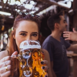 woman drinking large beer